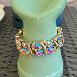 AB coated Crystal teardrop shaped stretch bracelet. Gold tone.